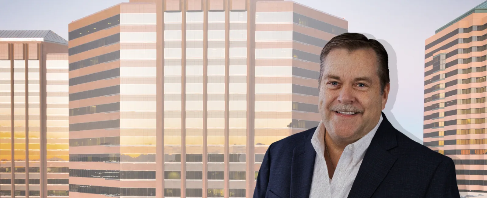 Smiling businessman in suit stands in front of high-rise office buildings with HR technology text overlay