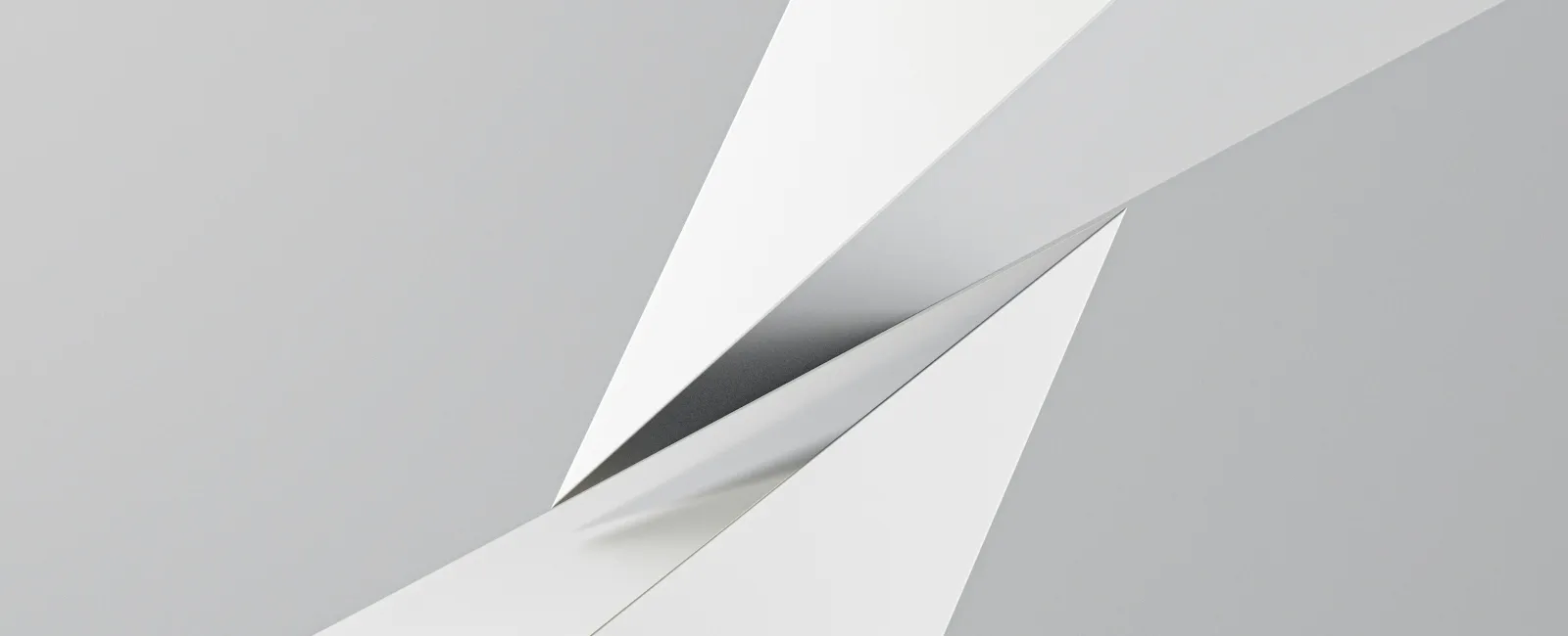 Abstract white paper planes intersecting dynamically against a light gray background with shadows.