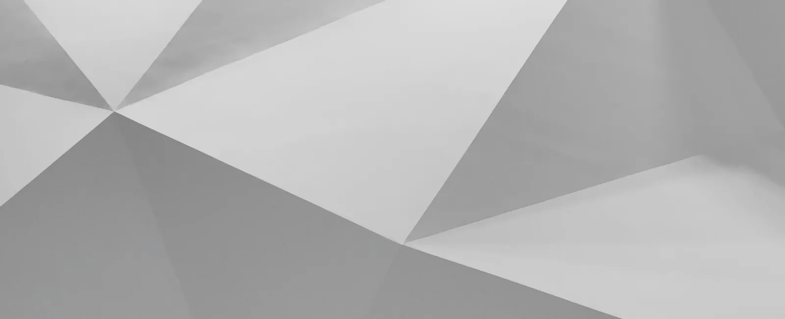 Abstract geometric pattern with white and gray triangular facets creating a 3D effect