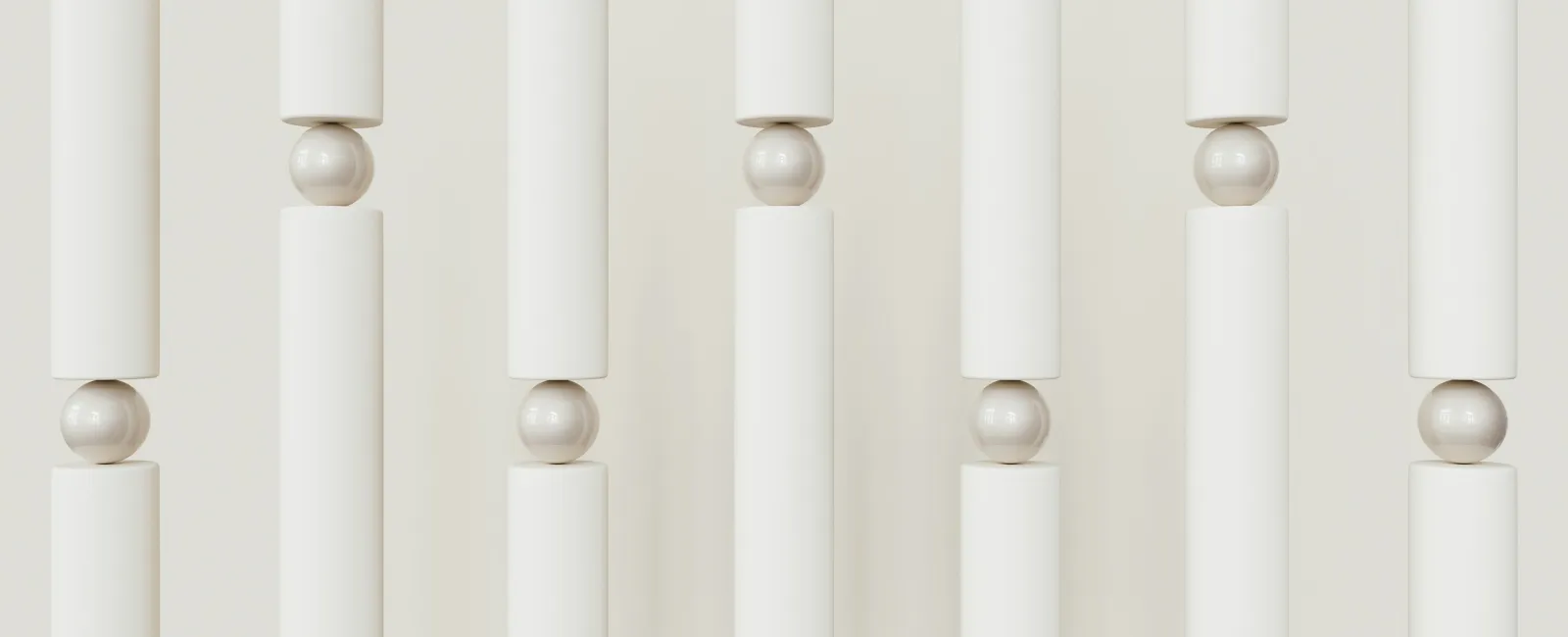 Vertical white cylinders balanced on white spheres creating a minimal geometric pattern with soft shadows.