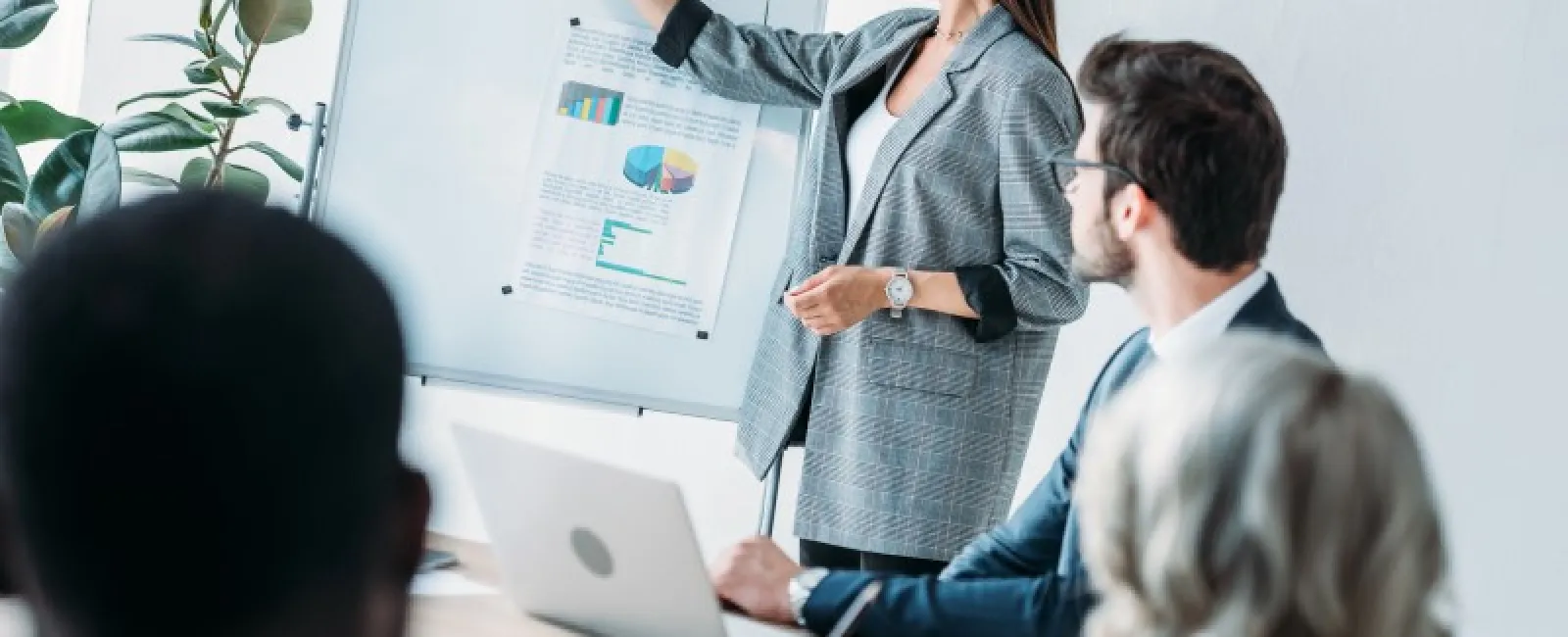 a woman presenting on a whiteboard