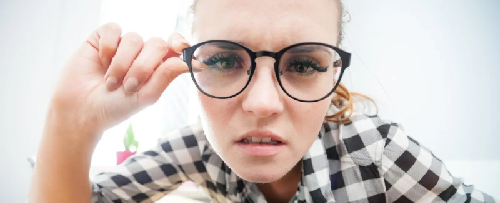 a person with glasses looking at a laptop