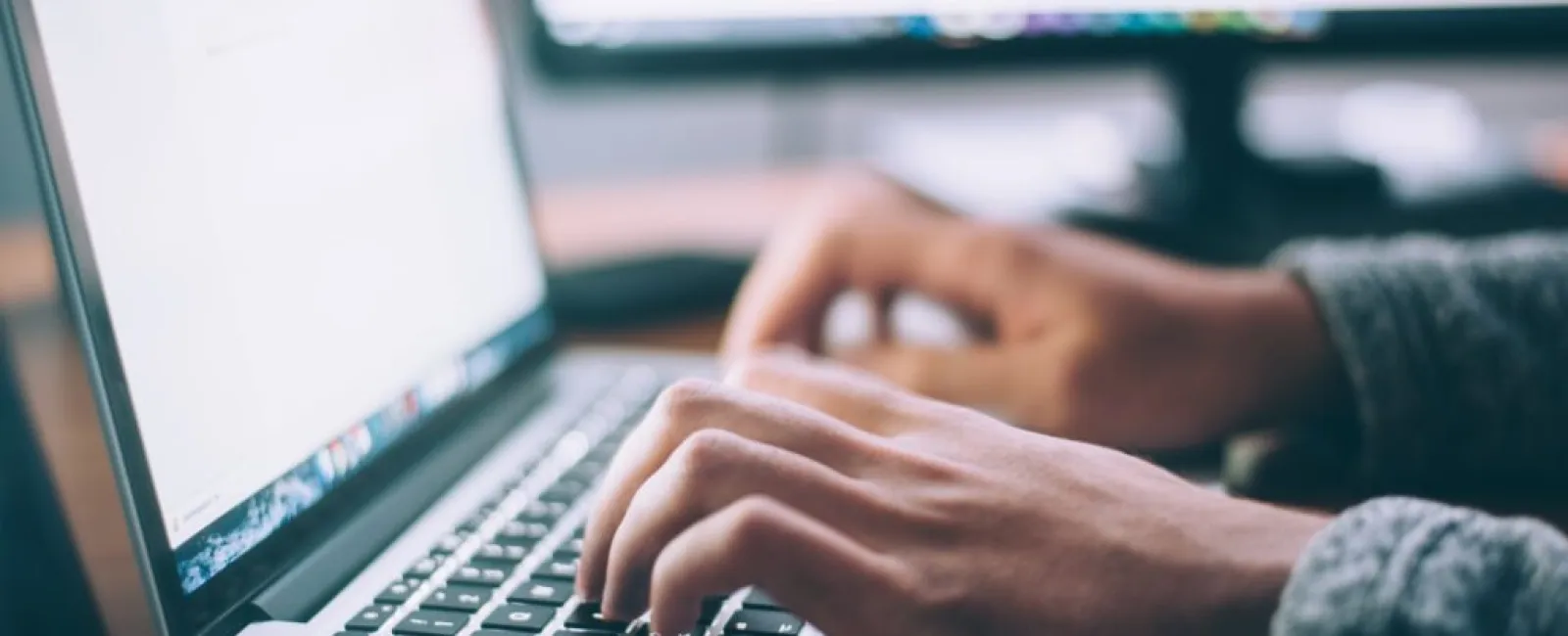 a person typing on a laptop