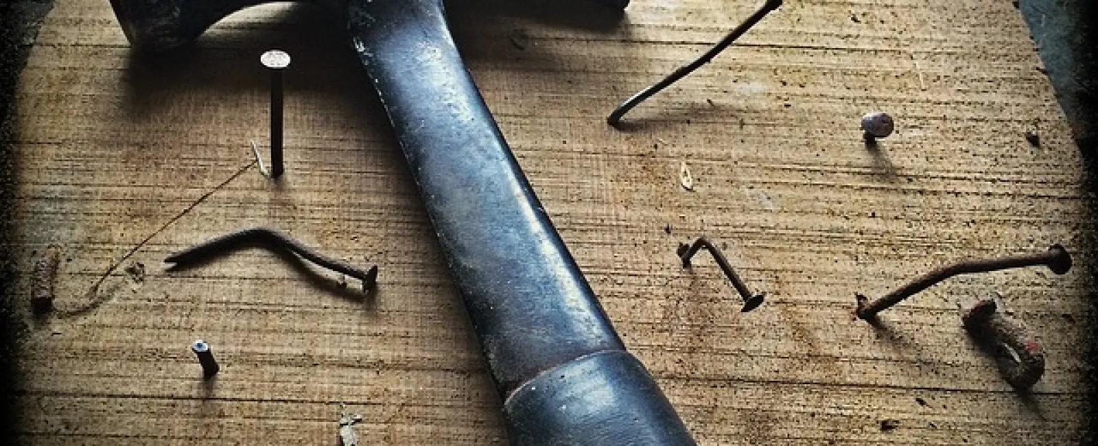 a hammer and nails on a table