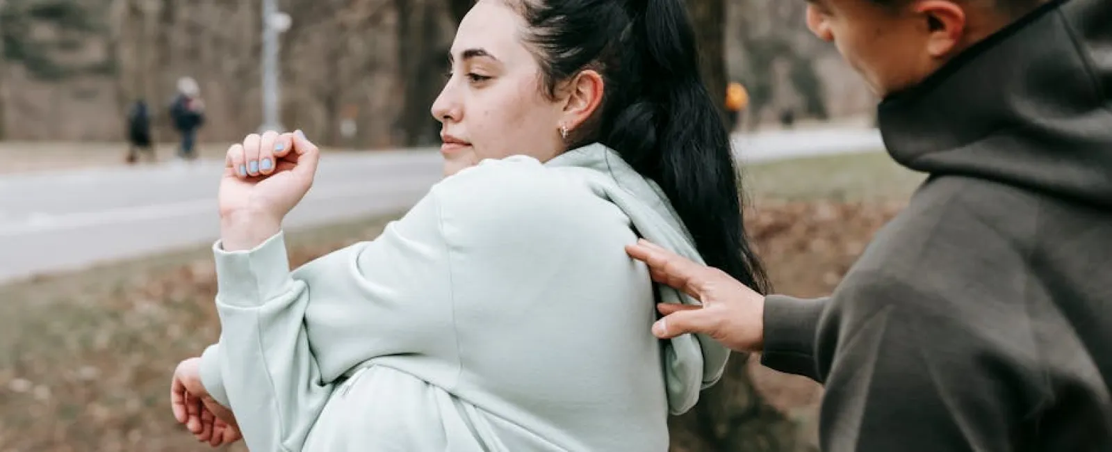 a man helping a woman stretch