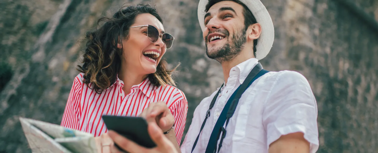 a man and woman looking at a phone