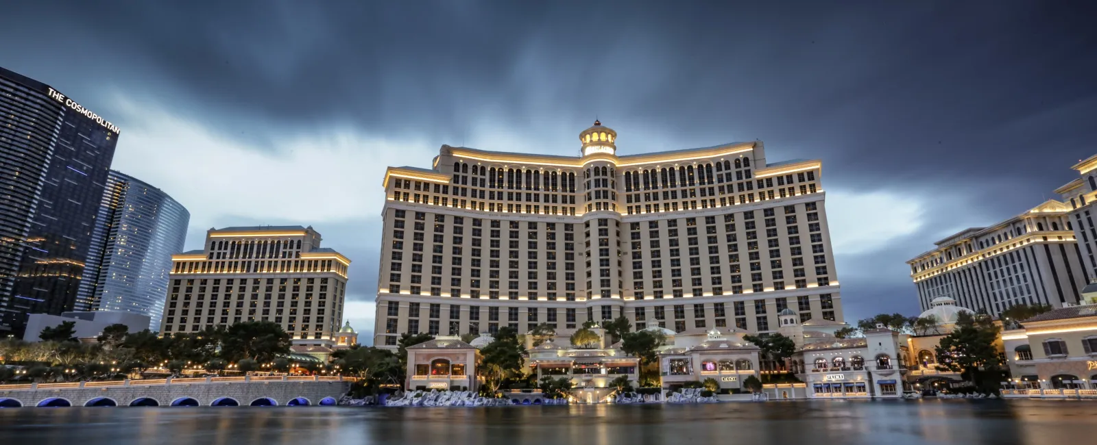 a large building next to a body of water with Bellagio in the background
