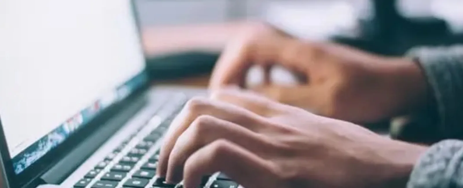 a person typing on a laptop