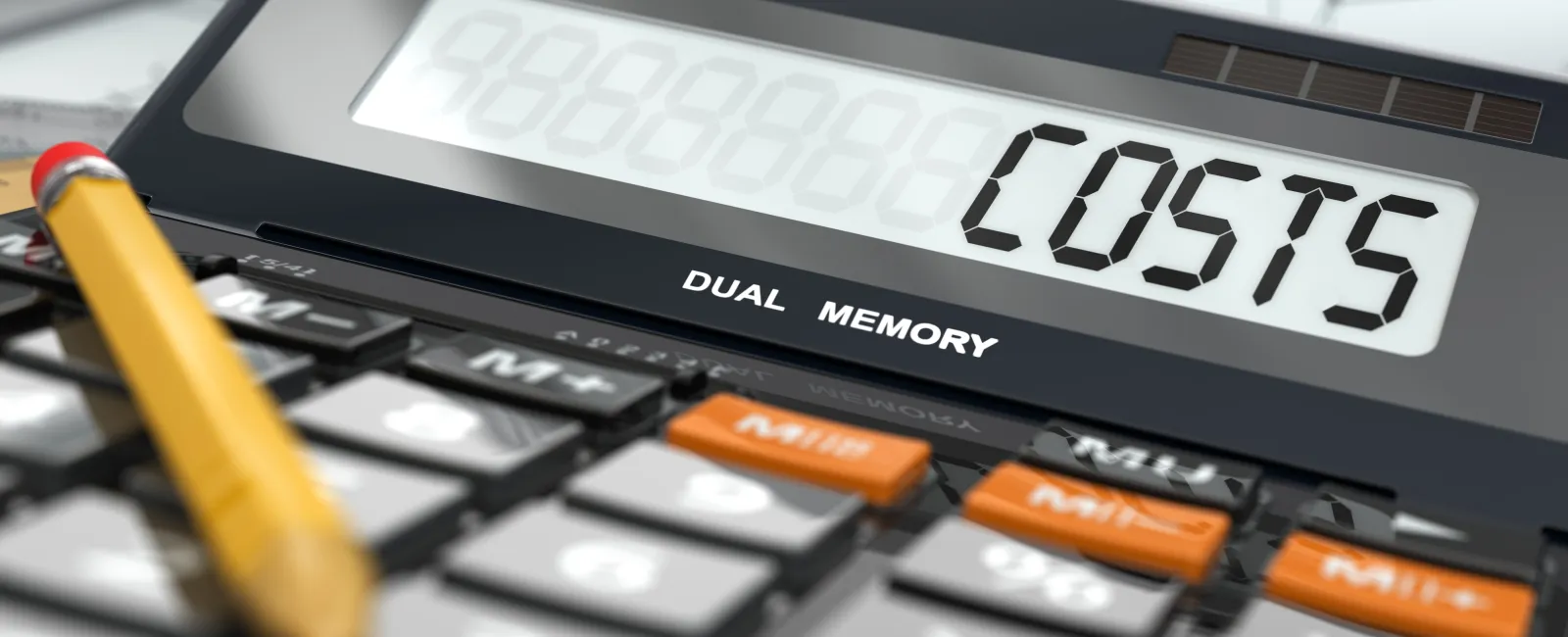 Close-up of a calculator displaying the word COSTS with rolled blueprints and a pencil nearby.