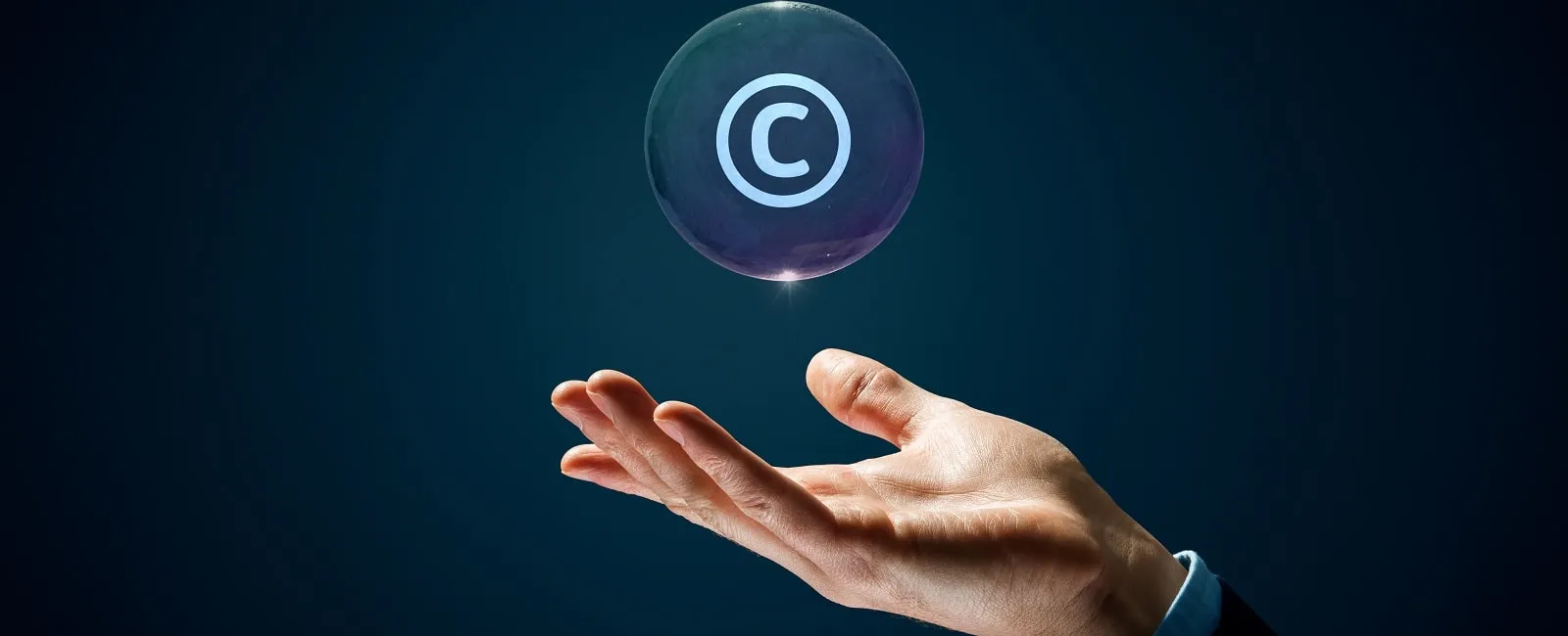a hand holding the copyright logo