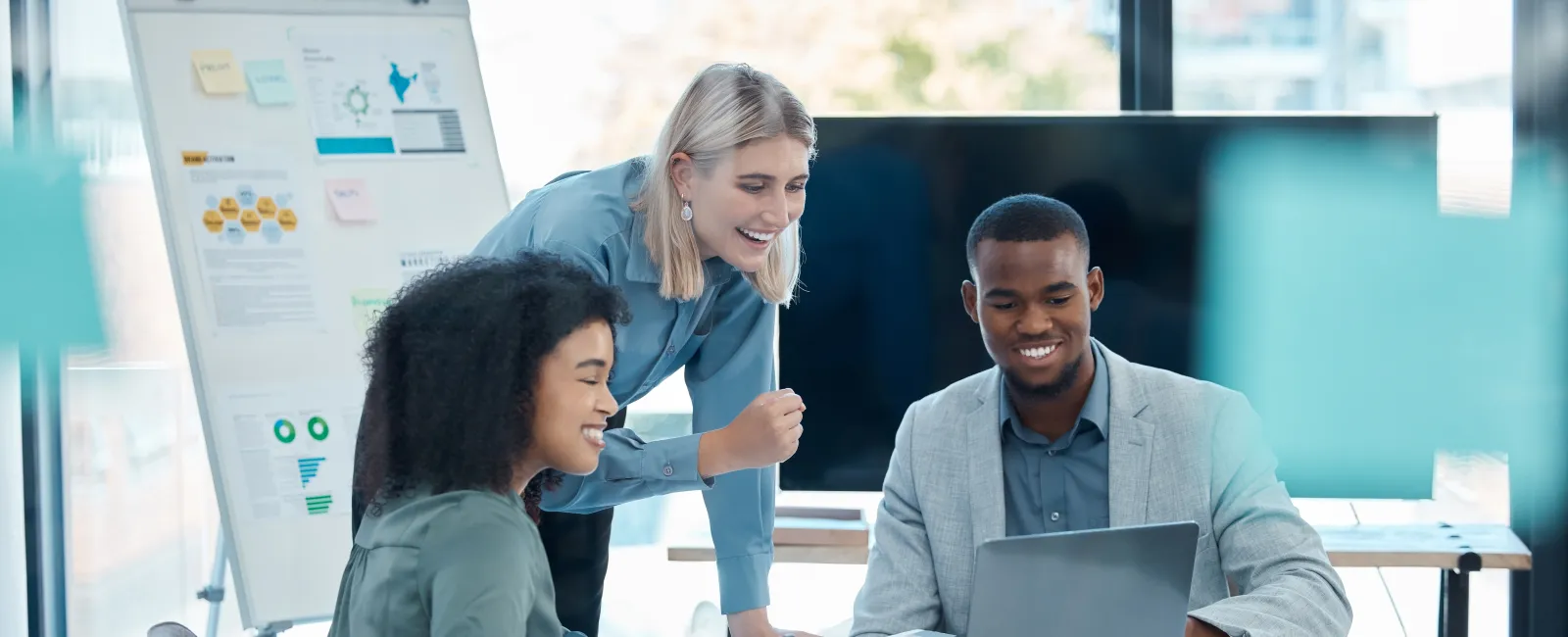 a few people looking at a laptop