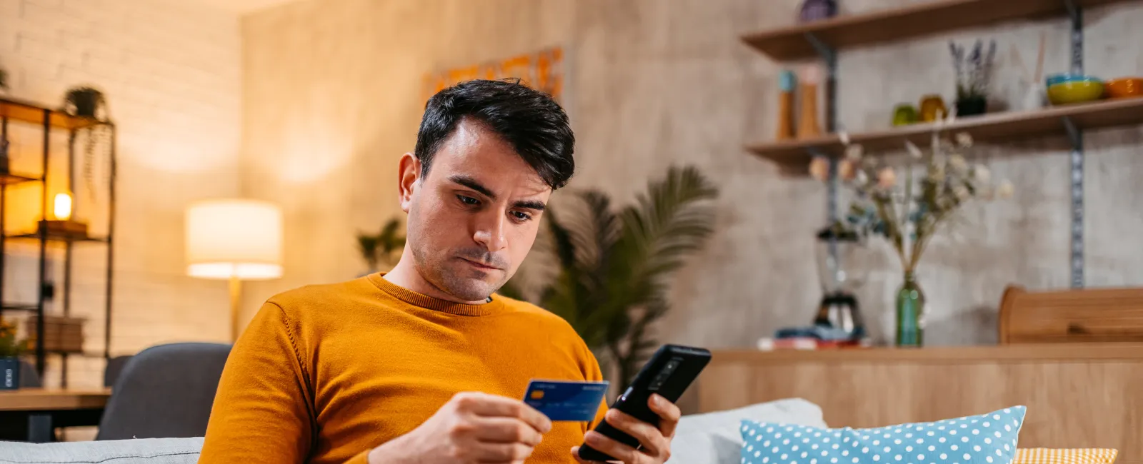 a person sitting on a couch looking at the phone