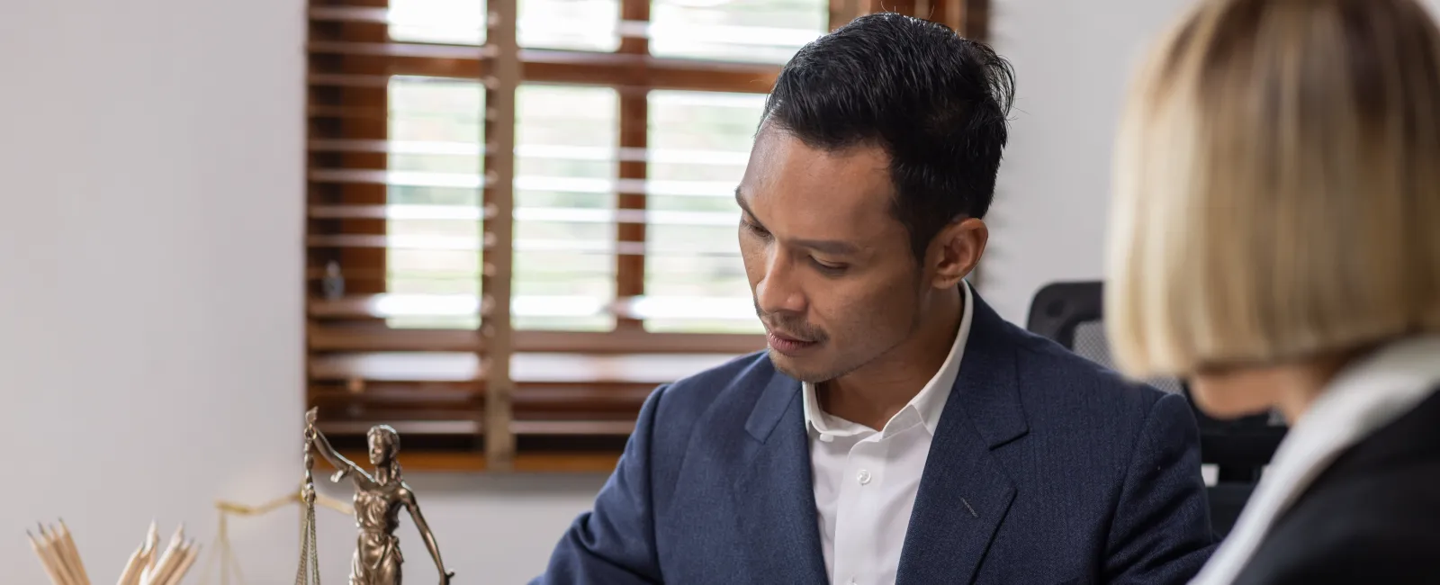 a man and a woman looking at a book