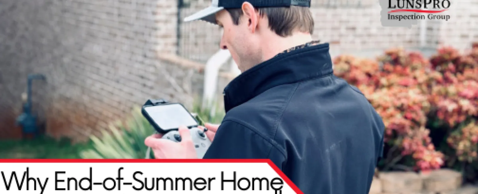 Home inspector using a device outside a brick house to prevent fall and winter issues after end-of-summer check.