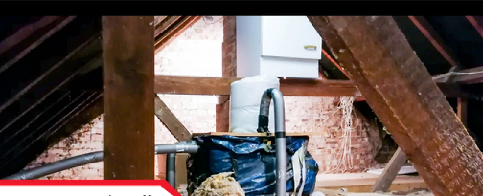Attic water shutoff valve surrounded by insulation and wooden beams under a roof structure.