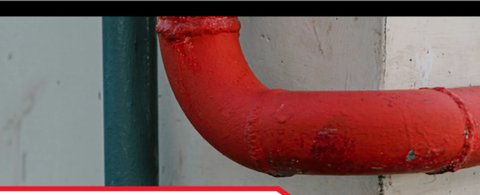Close-up of red firestop pipe on wall highlighting fire safety in new construction homes by LunsPro.