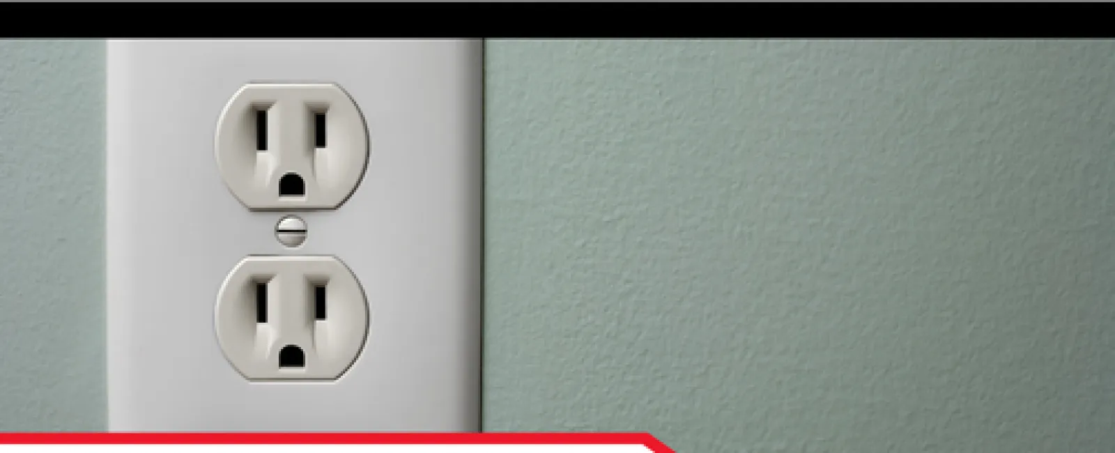 Close-up of a GFCI electrical outlet on a green wall with inspection branding and caption.