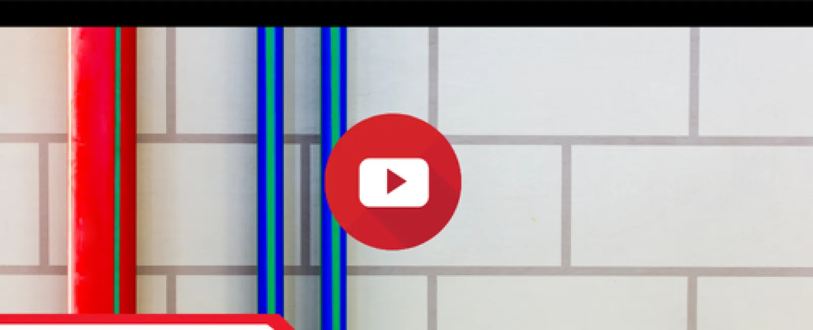 Red and blue pipes against a tiled wall with a missing clean out label and LunsPro Inspection Group logo.