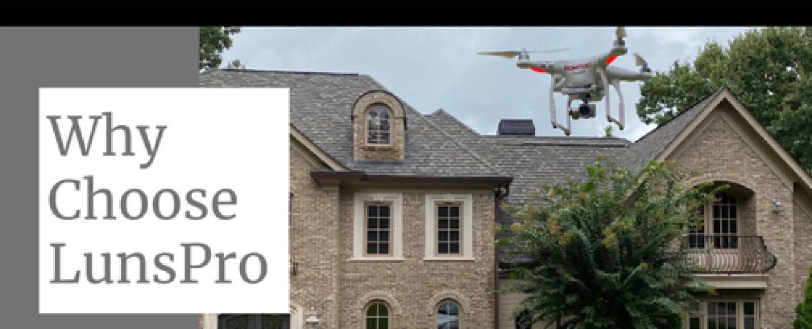 Drone flying over a large brick house with LunsPro inspection truck parked on the driveway demonstrating inspection services.