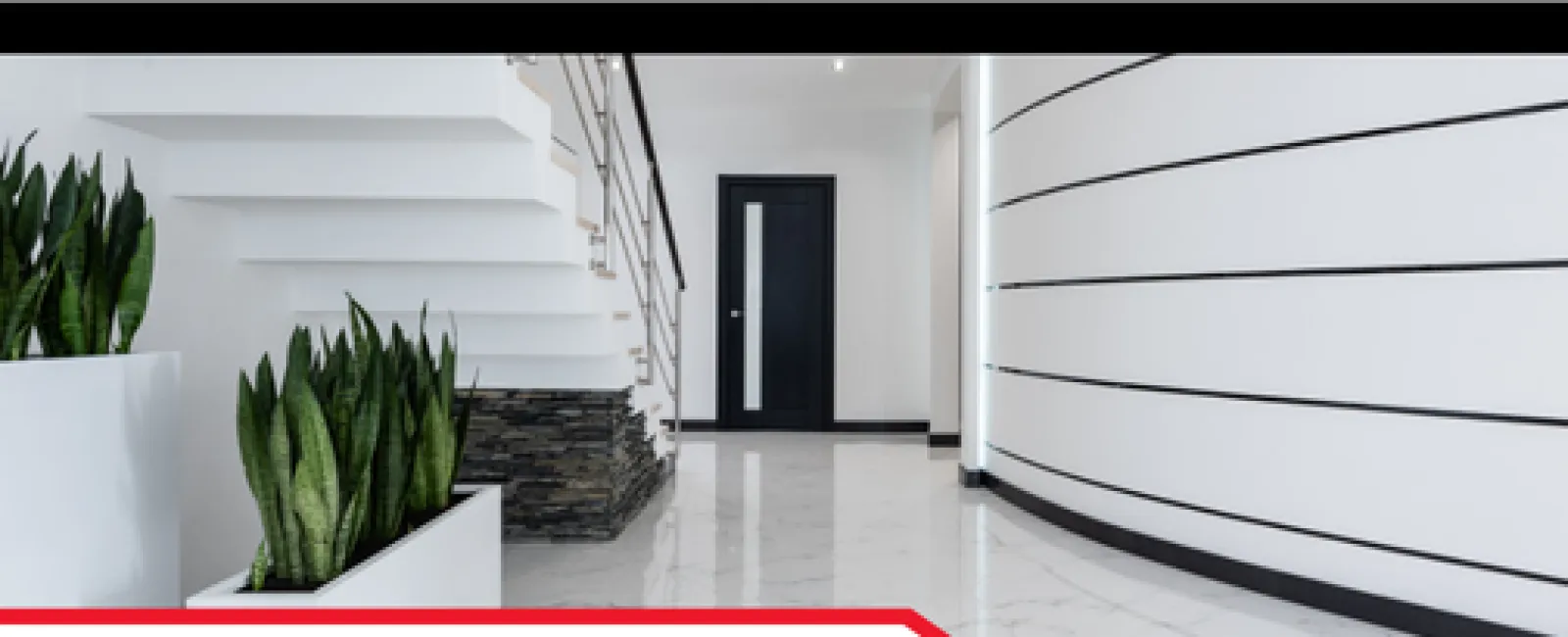 Modern interior with white marble floors, staircase, black door, and potted snake plants in a new construction space.