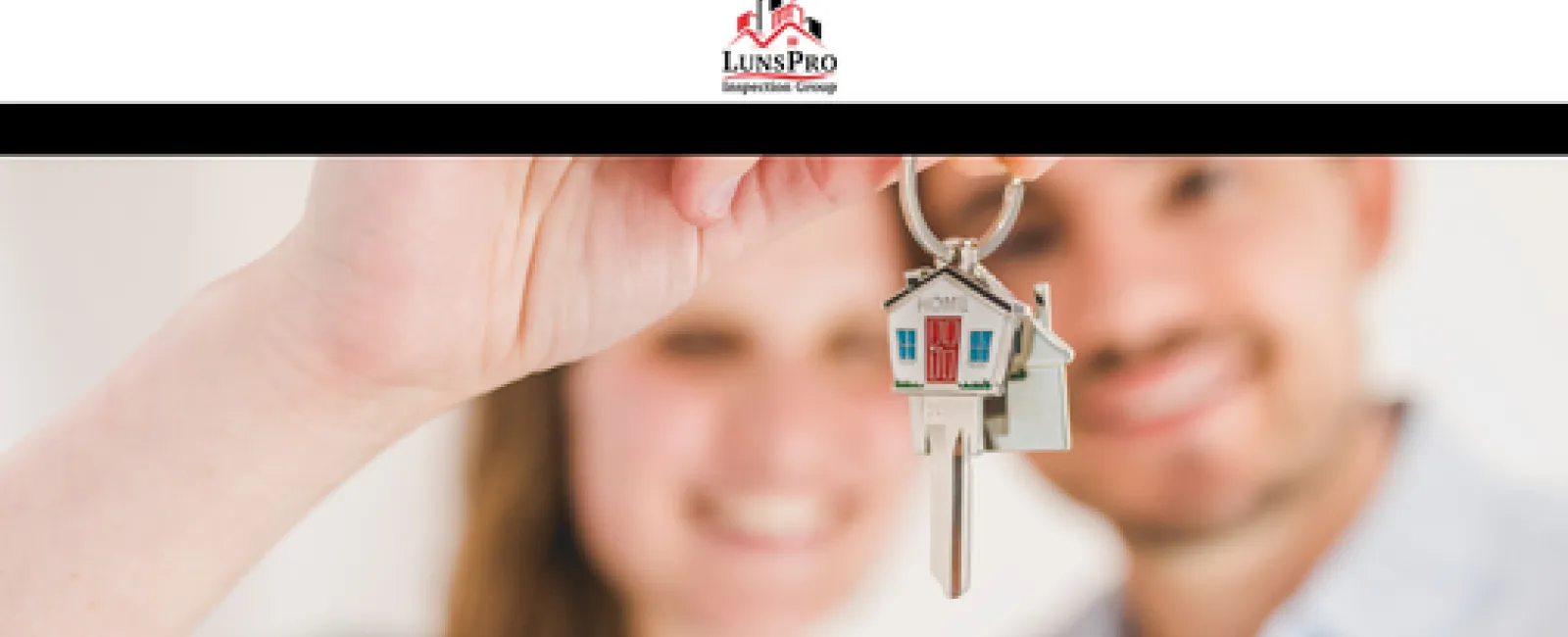 Happy couple holds house key with miniature home keychain symbolizing homeownership tips and advice.