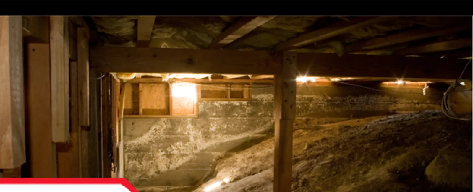 Dimly lit crawl space with wooden beams, dirt floor, insulation, and limited natural light from small window.