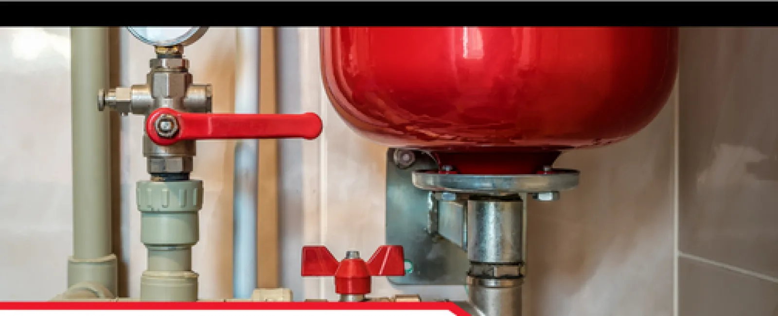 Close-up of a properly supported red expansion tank with valves in a home plumbing system
