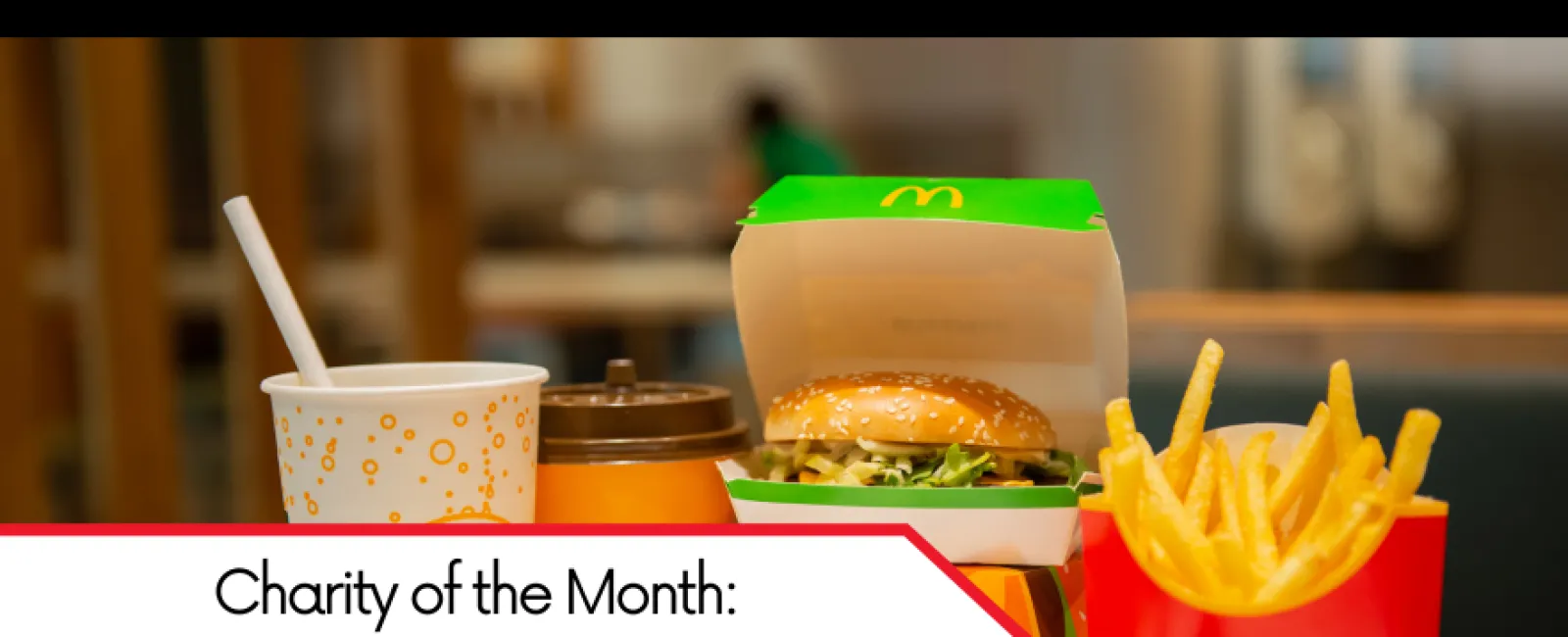 McDonald's meal with burger, fries, and drinks on a table highlighting September 2023 charity event.