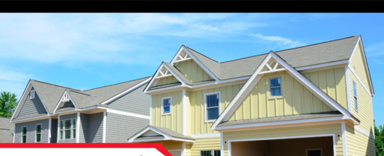 Newly constructed houses with fresh siding and roofing under a clear blue sky, showcasing modern home designs.