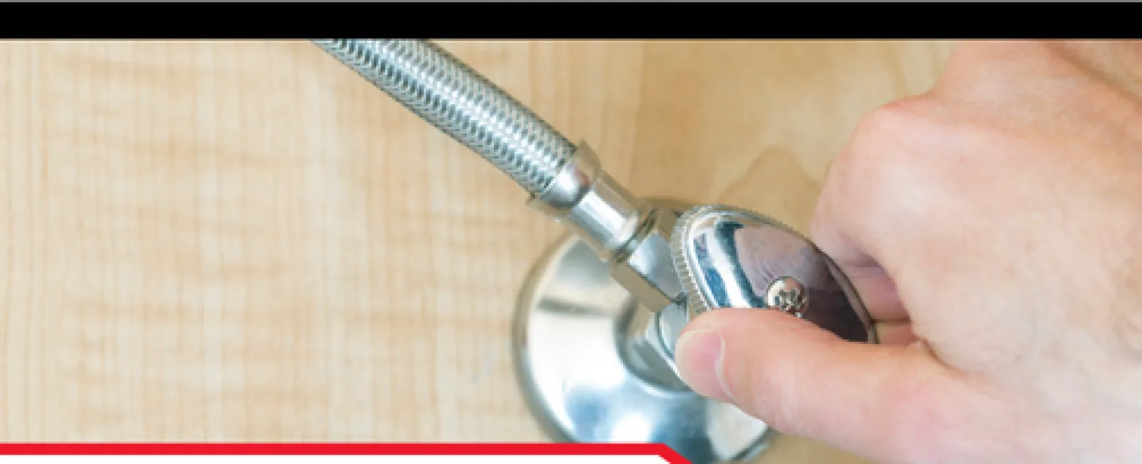 Hand turning a water shut-off valve outside on a wooden surface with instructional text below.