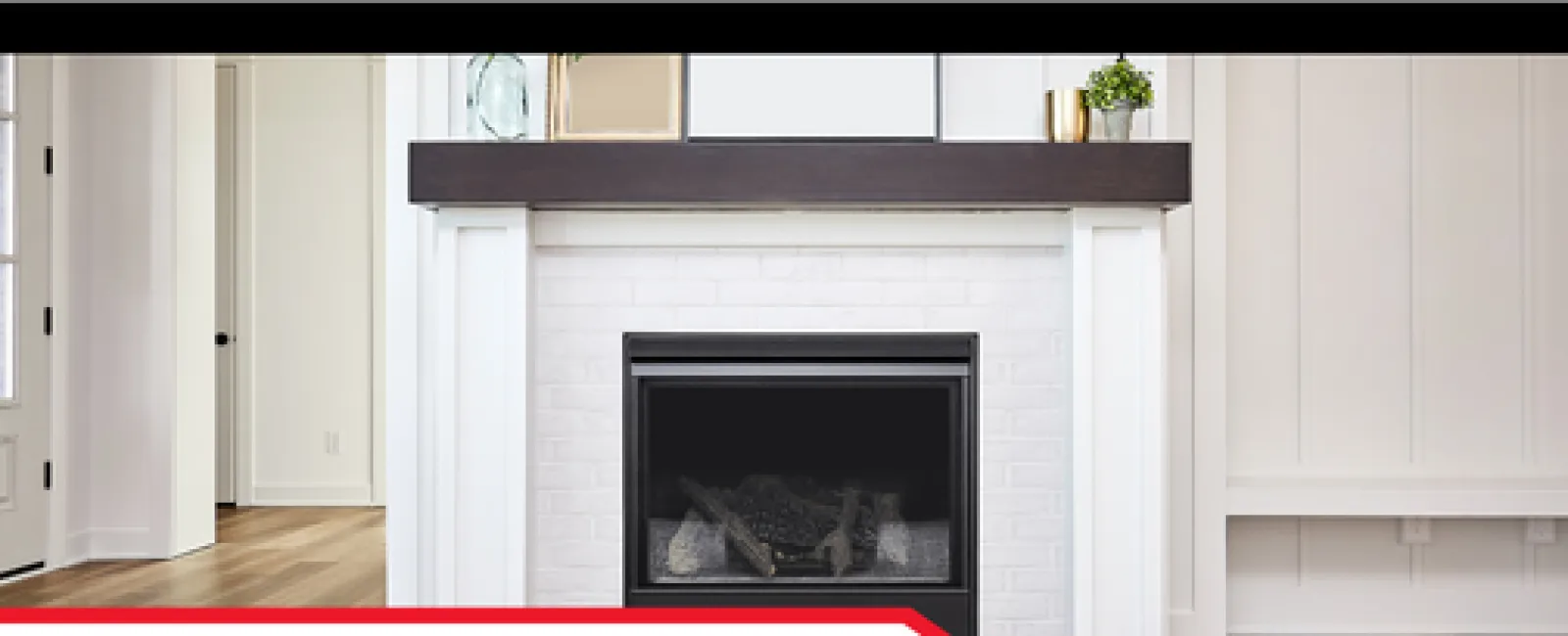 Modern white fireplace with dark wooden mantle and hardwood flooring in a bright, clean living room.
