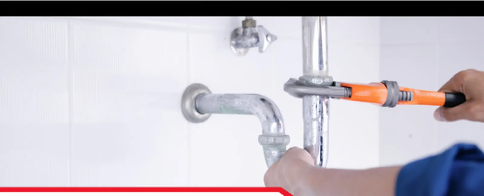 Plumber tightening a pipe under the sink with an orange wrench, highlighting home plumbing and P-traps.