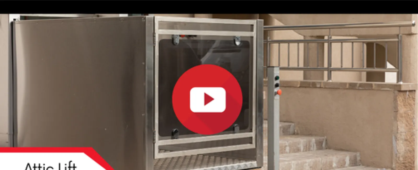 Stainless steel attic lift installed next to outdoor stairs with safety railing and control panel.