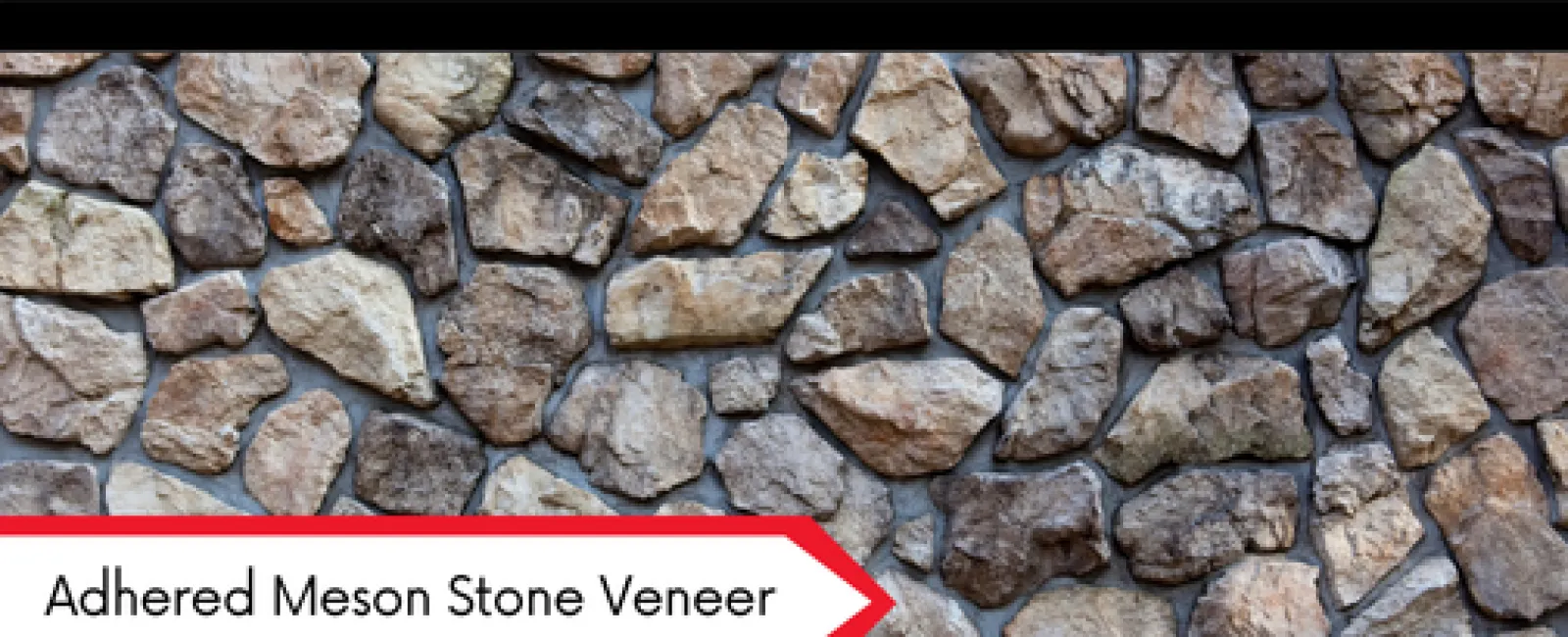 Close-up of adhered Meson stone veneer wall with irregular natural stones in various earth tones and textures.