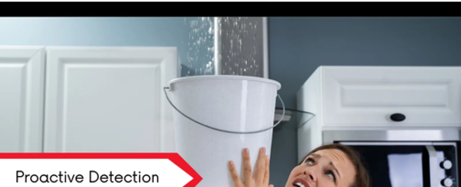 Woman holding bucket under leaking kitchen ceiling appearing worried, illustrating proactive detection of water leaks.