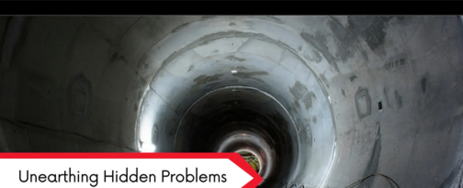 Interior view of a concrete tunnel with lighting, highlighting hidden structural issues for inspection.