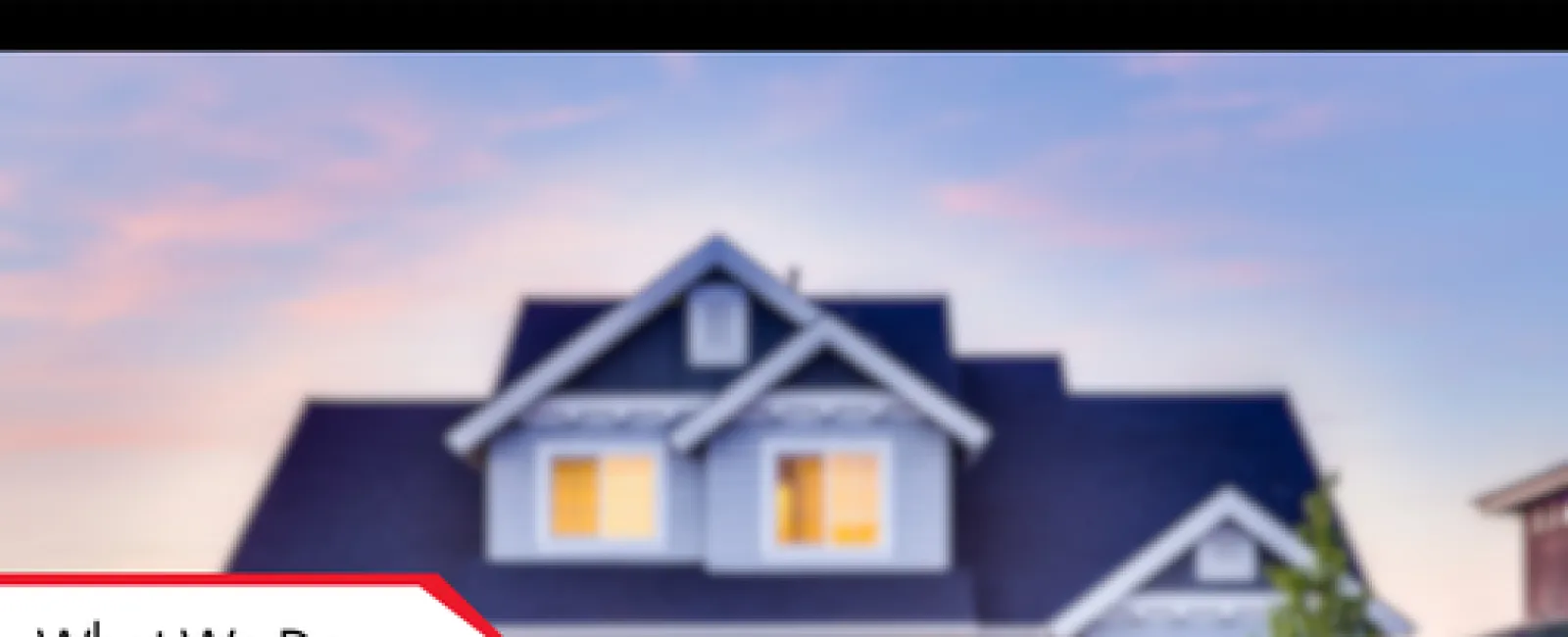 Modern two-story house at sunset with warm interior lights and a front yard tree under a clear sky.
