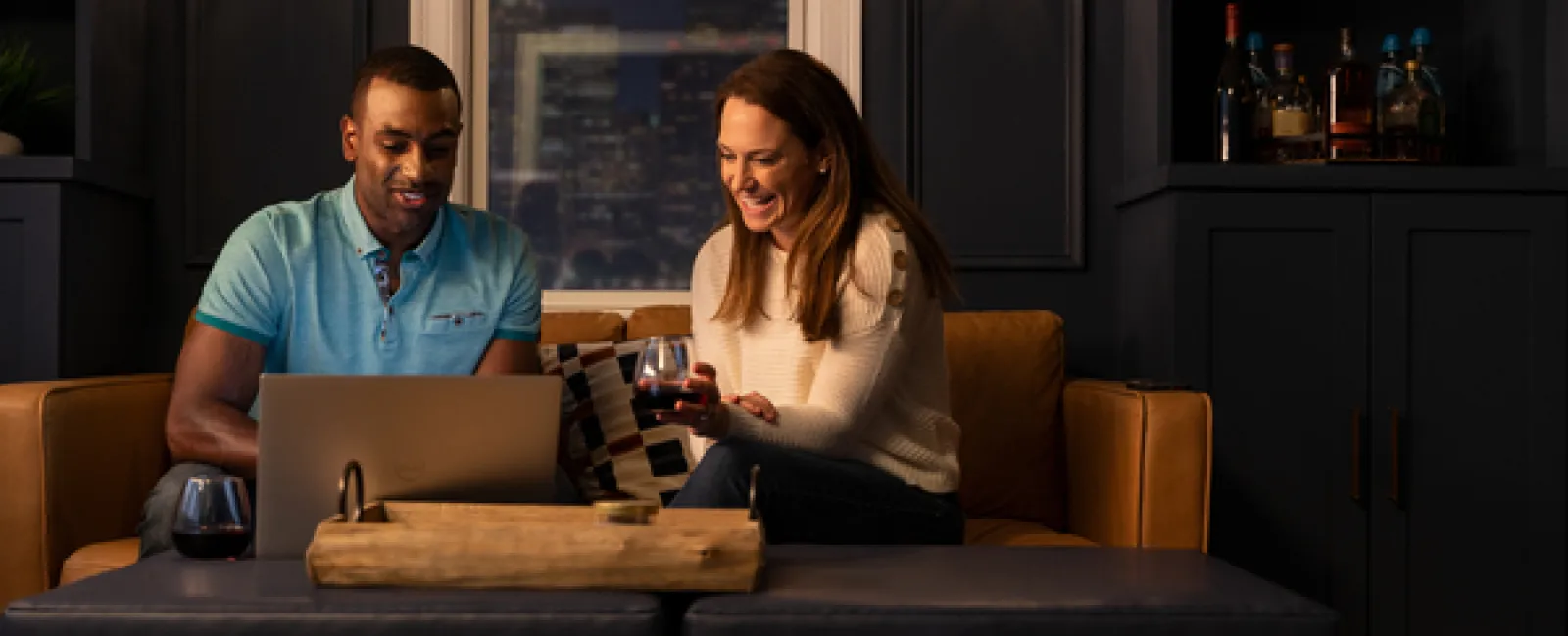 Two franchise owners drinking wine in their living room