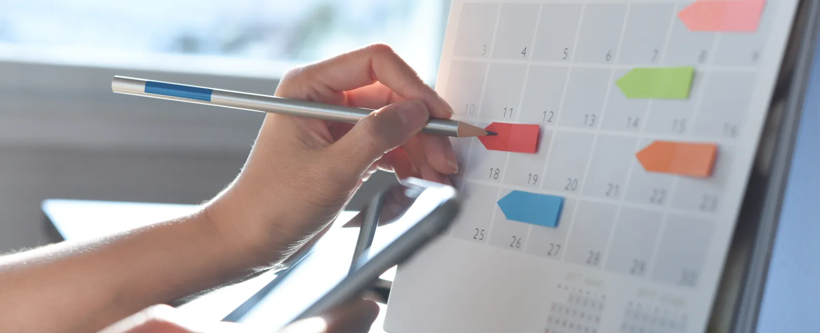 a person writing on a calendar