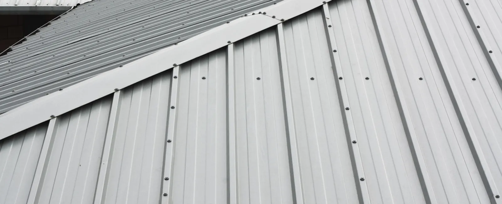 Close-up of a corrugated metal roof showcasing diagonal layering and texture.