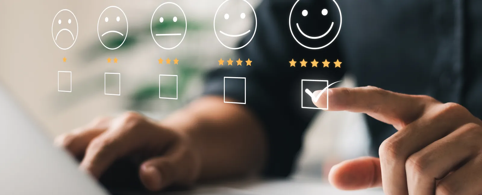 Person selecting five-star smiley face rating on a virtual feedback interface over a laptop keyboard.
