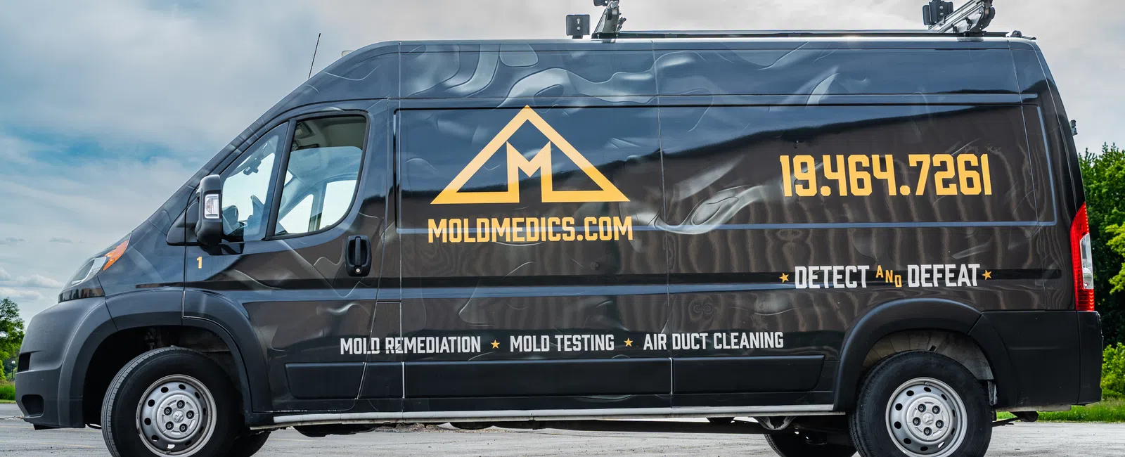Side view of Mold Medics black service van with company logo, phone number, and services listed, with overlaid text.
