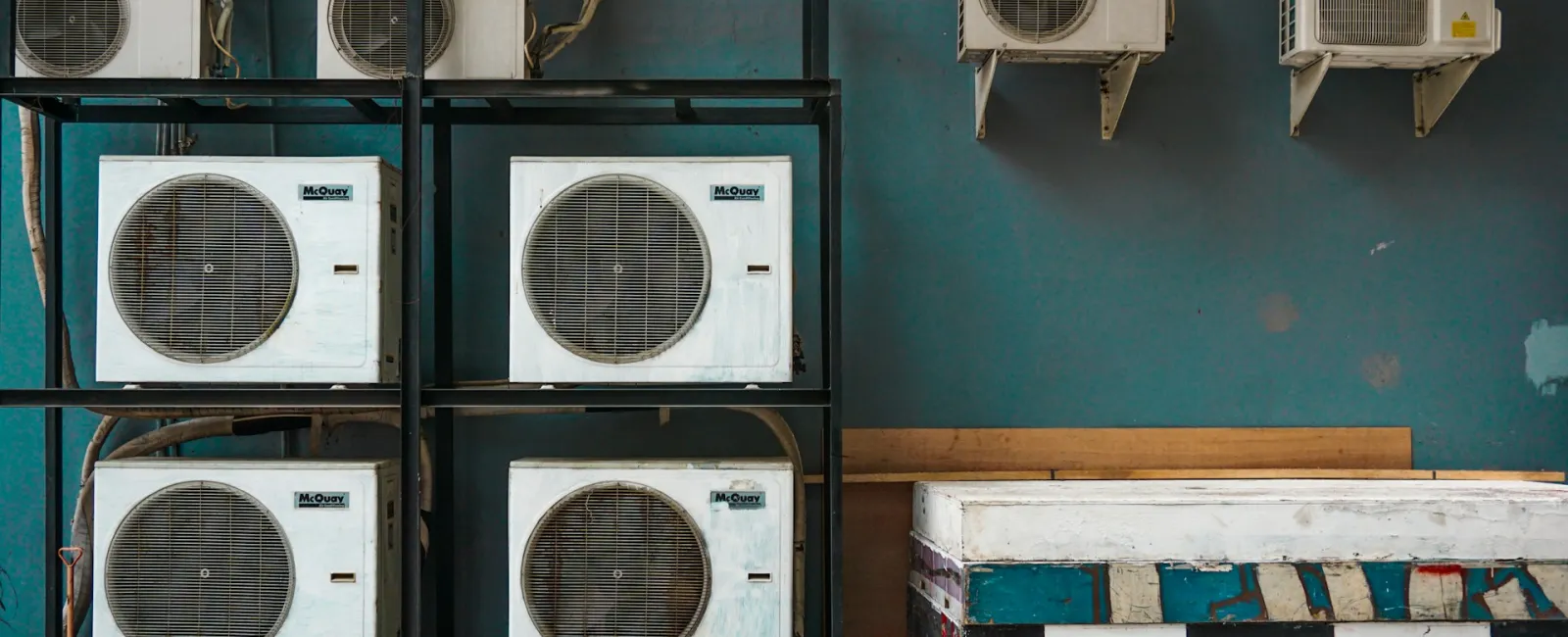 Array of LG air conditioning units mounted on a blue wall, showcasing industrial cooling solutions.
