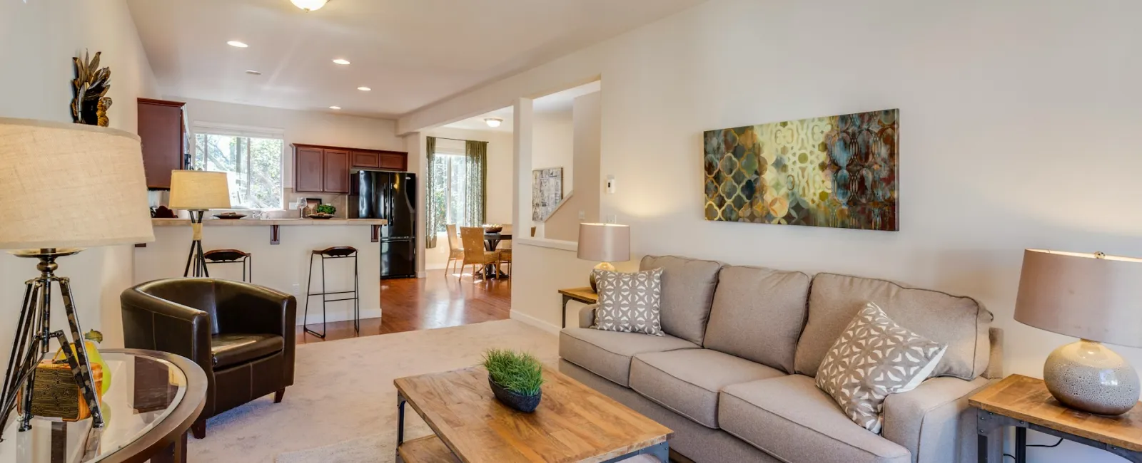 Cozy living room with modern furnishings, wooden accents, and bright natural light.