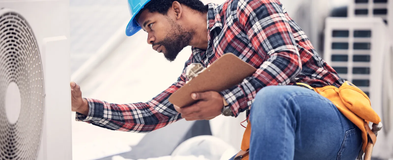 a man in a hard hat working on a machine