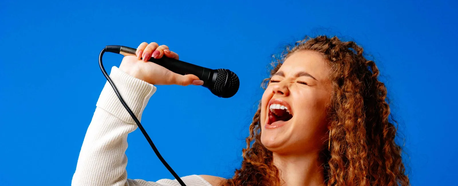 a person singing into a microphone