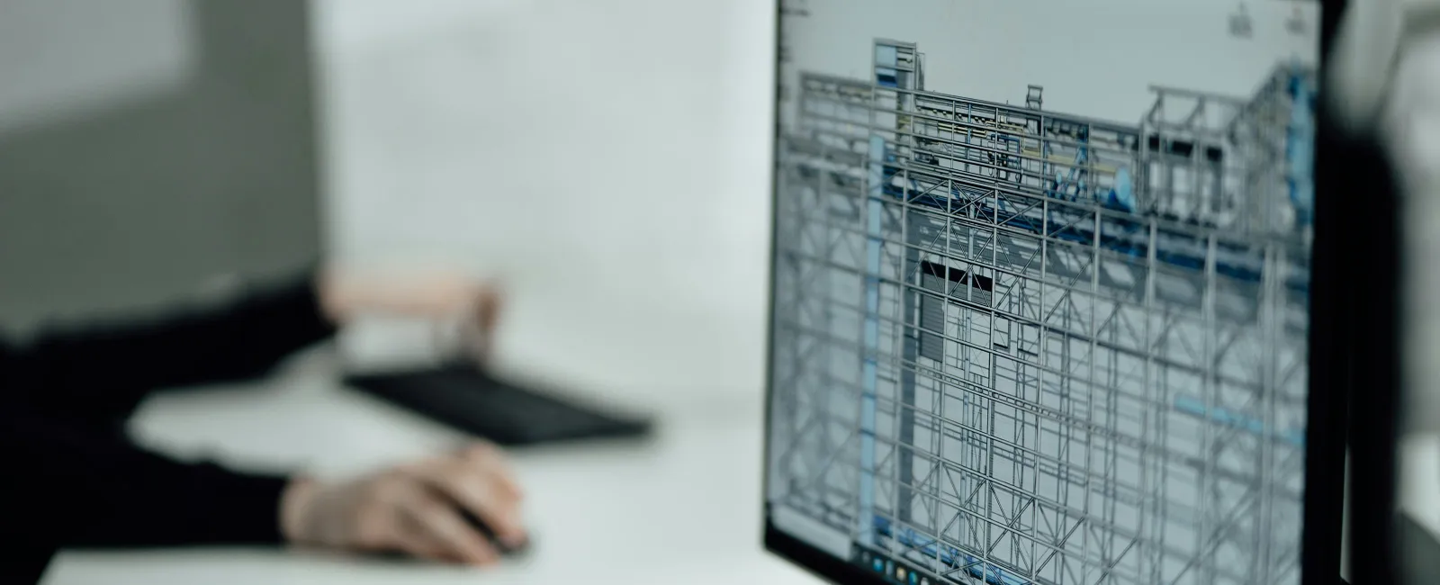 Computer screen displaying architectural 3D structural design with scaffolding and framework details