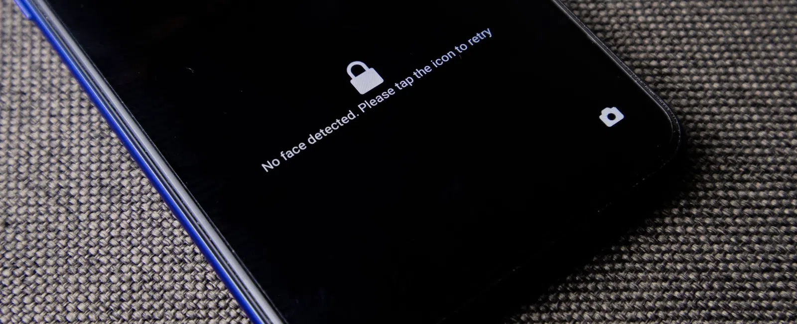 Smartphone screen displaying 'No face detected. Please tap the icon to retry' message with lock icon.
