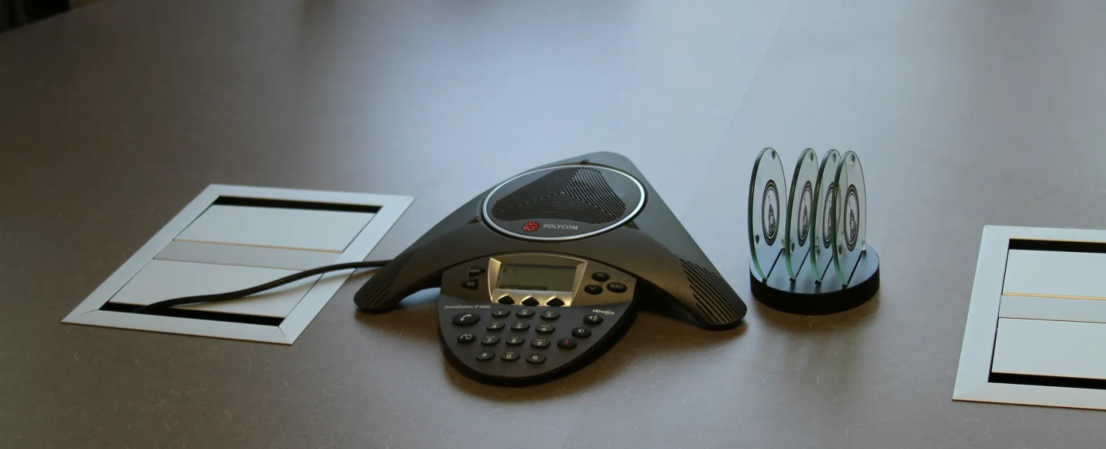 Conference table with a conference phone and papers.