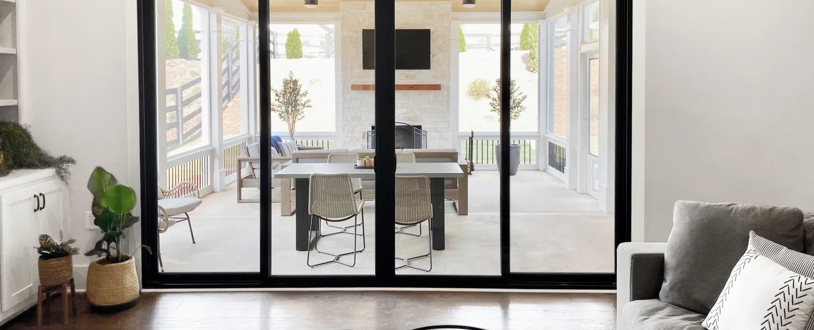 Contemporary living room with large sliding glass doors leading to a spacious outdoor area.
